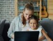 mother-and-daughter-looking-at-laptop-together