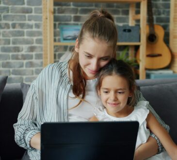 mother-and-daughter-looking-at-laptop-together
